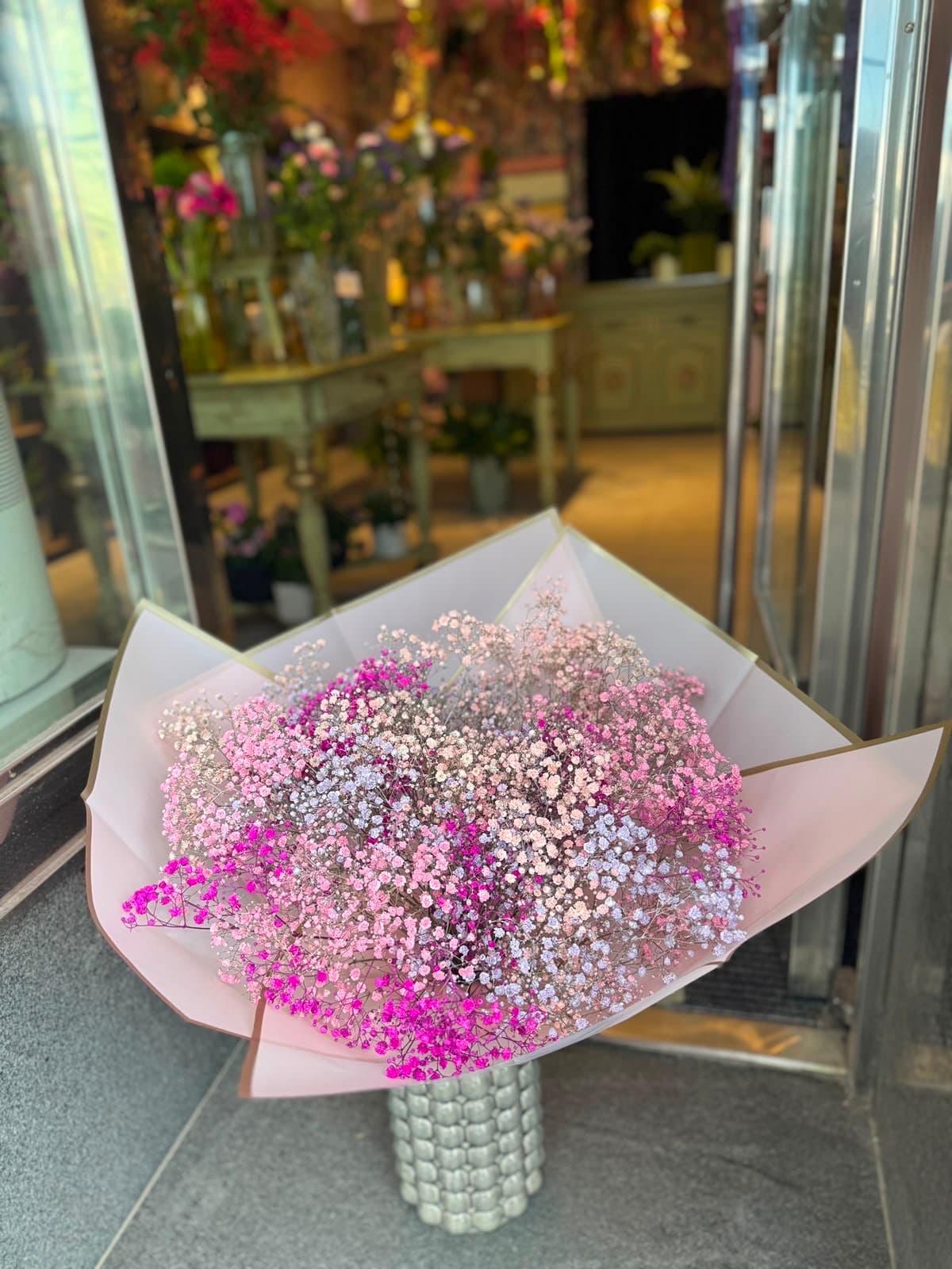 A bouquet by the shop's glass door