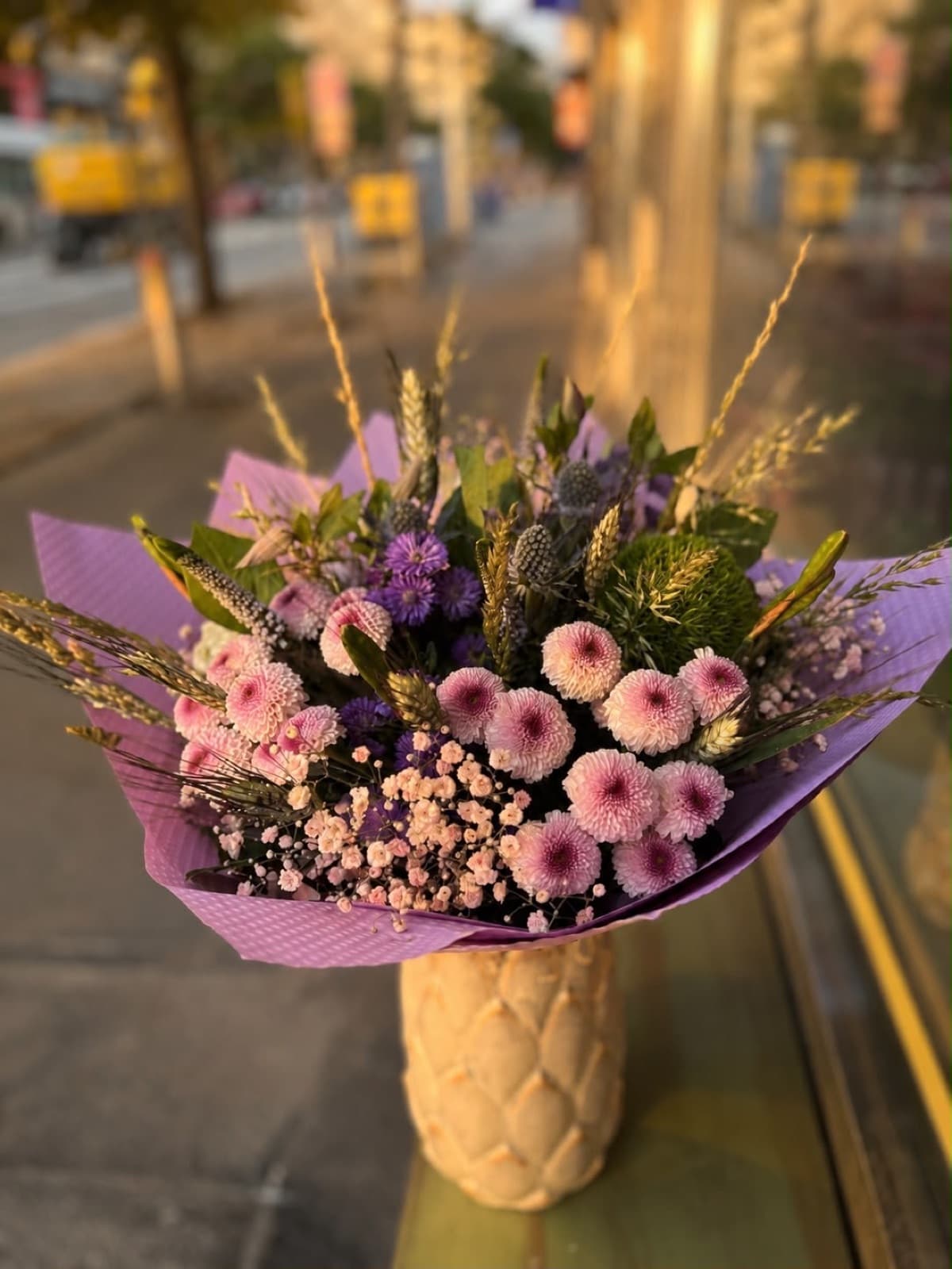 A bouquet on the windowsill by the entrance