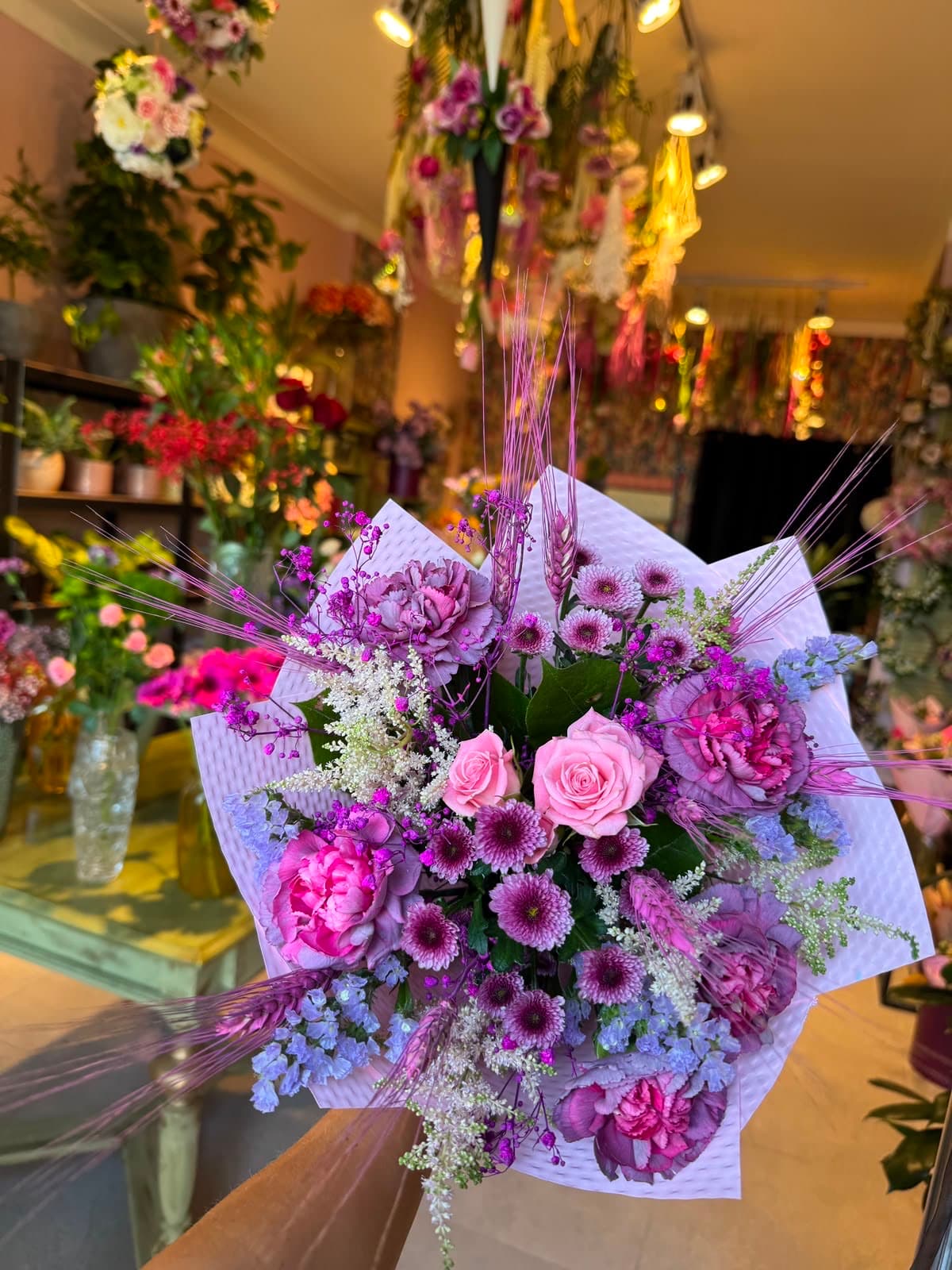 An arrangement in lavender and pink tones in a vase