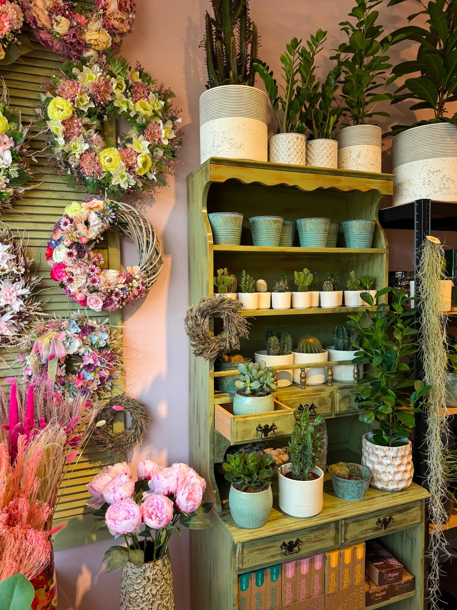 A shelf with wreaths and candles